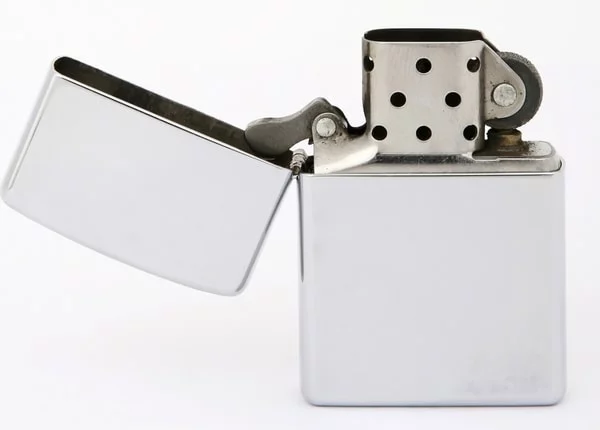 a silver lighter with a white background