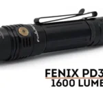 a black flashlight with a clip